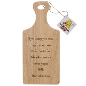 a wooden cutting board with a tag that says cheeseboard karaoke