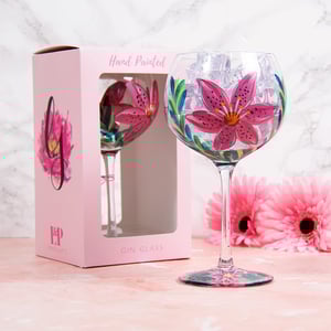 a hand painted gin glass in a pink box