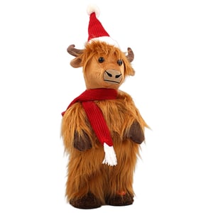 a stuffed cow wearing a santa hat and scarf
