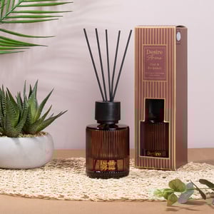 a desire aroma reed diffuser sits next to its box