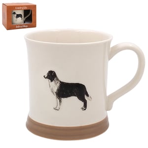 a white mug with a black and white dog on it