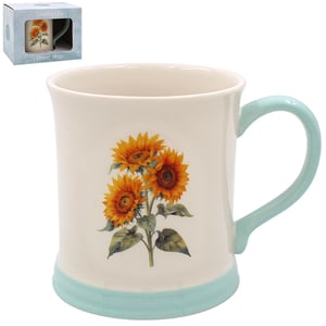 a white mug with sunflowers on it and a blue handle