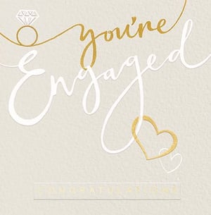 a congratulations card that says `` you 're engaged '' with a diamond ring and two hearts .