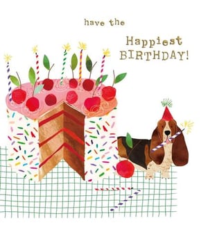 a dog is sitting next to a birthday cake with cherries and sprinkles .