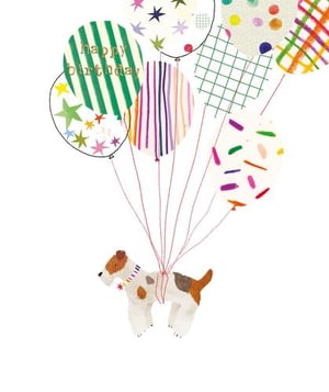 a dog is flying through the air with balloons .