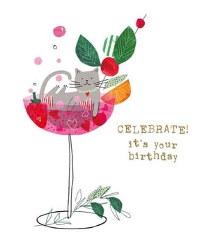 a cat is sitting in a martini glass filled with fruit .