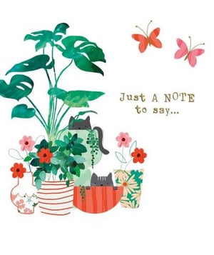 a cat is sitting in a potted plant with flowers and butterflies .