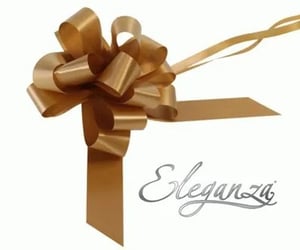 a gold bow with a ribbon attached to it is on a white background .