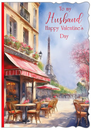 Capture the romance of Paris this Valentine's Day with our exquisite 'Husband' card, brought to you by Out of The Blue Studios Ltd. This charming watercolour design transports you to a picturesque Parisian street, complete with a cosy cafe adorned with vibrant flowers and the iconic Eiffel Tower shimmering in the distance.

Perfect for expressing heartfelt love, this card features the warm message "To my Husband Happy Valentine's Day" in elegant red script. Its beautiful artistry and tender sentiment make it an ideal choice for customers looking to celebrate their special someone. Stock up on this delightful design, available in a convenient pack of 6, and add a touch of Parisian charm to your Valentine's collection.