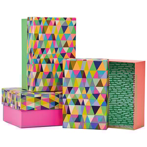 four colorful boxes with triangles on them are stacked on top of each other