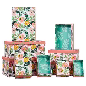 a stack of boxes with flowers and leaves on them