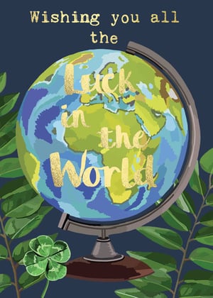 a globe with the words `` wishing you all luck in the world '' written on it .