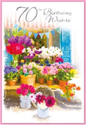 a 70th birthday wishes card with a bunch of potted flowers on a table .