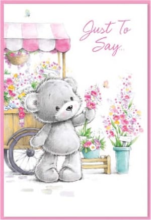 a teddy bear is holding a flower in front of a cart of flowers .