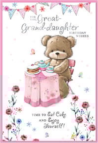 a teddy bear is sitting at a table with a cake on it .