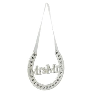 a silver horseshoe with the words mr. and mrs. written on it .