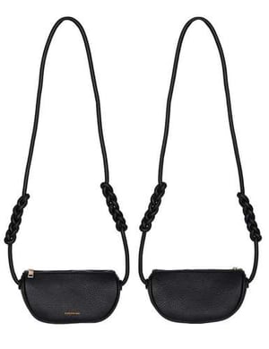a pair of black leather handbags with long straps on a white background .