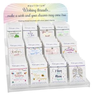 a display of wishing thread bracelets with silver plated charms .