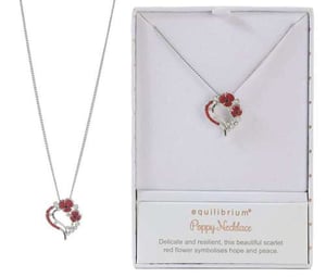a poppy necklace with a heart shaped pendant in a box .