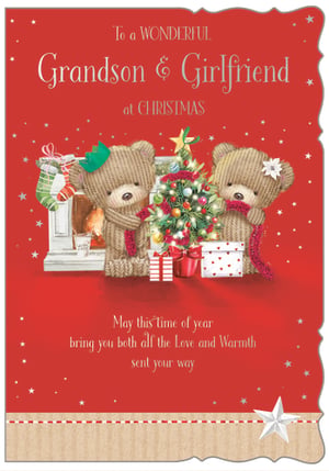 This delightful Grandson & Girlfriend Christmas card from Out of The Blue Studios Ltd. is the perfect way to send festive cheer to a special couple. The charming design features two adorable knitted teddy bears, one wearing a crown and the other a flower, busily decorating a sparkling Christmas tree. A cosy fireplace with stockings and neatly wrapped presents complete this heartwarming scene. The card's message, "May this time of year bring you both all the Love and Warmth sent your way," adds a touch of genuine affection. Set against a vibrant red background with twinkling stars and finished with a stylish bottom border, this card truly stands out. Available in a convenient pack of 6, it's ideal for retailers looking to offer a thoughtful and sweet option for the festive season.
