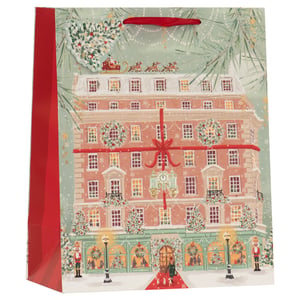 Elevate your customers' gift-giving experience this festive season with our Large Christmas Shopping Gift Bag, supplied by Partisan Products Ltd. This enchanting bag showcases a beautifully detailed illustration of a grand building, adorned with festive wreaths, twinkling lights, and a magnificent red ribbon, making it look like a giant present. Above, Santa and his reindeer add a magical touch to the snowy landscape. Perfect for larger purchases, this bag transforms any gift into a truly special Christmas treat. The vibrant red handles and coordinating side panel enhance the intricate design, ensuring a memorable presentation. Offered in a convenient pack of 6, these bags are an ideal choice for retailers seeking premium, eye-catching festive packaging.