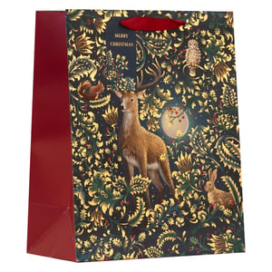 Make your gifts truly special this festive season with our enchanting Large Enchanted Forest Gift Bag. This beautiful bag features a captivating design, showcasing a majestic stag, a wise owl, a curious squirrel, and a charming rabbit nestled within a rich tapestry of golden and green foliage. The deep red side panels and handles add a luxurious touch, perfectly complementing the 'Merry Christmas' message. Ideal for larger presents, these bags are designed to add a touch of woodland magic to any gift-giving occasion. Available in a convenient pack of 6, exclusively from Partisan Products Ltd.