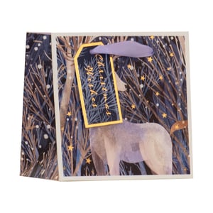 Present your thoughtful gifts in style with our enchanting Extra Small Magical Reindeer Gift Bag. This delightful bag features a serene winter forest illustration, complete with delicate bare trees dusted with snow and shimmering golden stars. A majestic reindeer stands gracefully amidst the magical scene, creating a truly captivating design.

Each bag comes adorned with a charming 'Christmas Wishes' gift tag, beautifully edged in gold and tied with a soft purple ribbon, adding a touch of elegance to any present. Ideal for small, precious items, these bags are perfect for spreading festive cheer. Available in convenient packs of 6, they're ready to make your customers' gifting moments extra special this holiday season.
