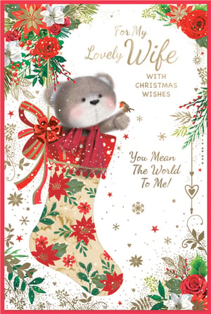 Make her Christmas truly special with this utterly charming 'Wife' Christmas card from Simon Elvin. Featuring an adorable teddy bear peeking out from a beautifully decorated festive stocking, this card is sure to melt her heart. The sweet bear, complete with rosy cheeks and a cosy red scarf, holds a tiny robin, adding a touch of winter wonder.
The elegant stocking is adorned with classic red poinsettias and lush green foliage, all set against a sparkling, snow-kissed background. The heartfelt message, "For My Lovely Wife WITH CHRISTMAS WISHES You Mean The World To Me!", perfectly conveys deep affection. Stock this delightful card to offer your customers a truly memorable way to express their love this holiday season. Available in a convenient pack of 6.