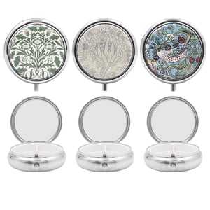 Introduce a touch of timeless elegance to your customers' daily routine with our exquisite William Morris Pill Box 3 Asst. Sourced from Lesser and Pavey Ltd., these charming pill boxes feature three distinct and iconic William Morris designs, ensuring a delightful choice for every taste.

Each compact, silver-toned box opens to reveal three convenient compartments, perfect for organising medication or small trinkets, along with a handy mirror in the lid. Their beautiful patterns, from classic foliage to a whimsical bird and berry motif, make them a stylish and practical accessory.

Available in a wholesale pack of 1x12, these assorted pill boxes are ideal for gifting or personal use, offering both beauty and utility. A truly lovely addition to any retail collection.