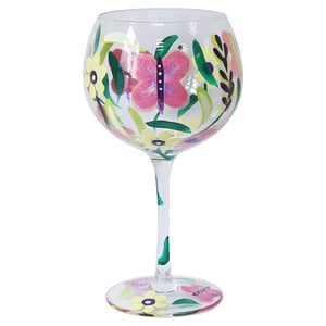 Brighten up any occasion with our charming Butterflies Gin Glass. This beautifully hand-painted glass features a lively design of pink butterflies, yellow flowers, and green foliage, bringing a touch of nature's beauty to every sip. The colourful artwork extends from the spacious bowl down the elegant stem to the base, ensuring a delightful visual experience. Each glass is a unique piece, perfect for gin lovers or as a thoughtful gift. Supplied as a single item by Lesser and Pavey Ltd, it's an ideal addition to any homeware collection looking for a splash of vibrant design.