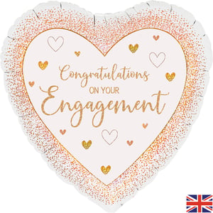 Congratulate the happy couple in style with our elegant 18" Engagement Rose Gold Heart balloon. This beautiful heart-shaped foil features a sophisticated rose gold glitter design, framing the heartfelt message 'Congratulations ON YOUR Engagement'. Adorned with charming little hearts, it's the perfect way to add a touch of sparkle to any engagement celebration. Measuring 18 inches, it makes a wonderful gift or a delightful decoration for their special day. Available individually, this balloon is a lovely choice to mark such a joyous occasion.