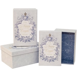 Introduce a touch of timeless elegance to your gift-giving with our Wedding Toile 3 Nested Boxes, brought to you by Partisan Products Ltd. This delightful set features three beautifully crafted boxes, designed to nest perfectly for convenient storage. Each box boasts a classic blue and white toile pattern, elegantly framing the heartfelt message 'To the Happy Couple' – making them absolutely perfect for wedding gifts, keepsakes, or charming decorative displays. The intricate design, topped with a subtle regal motif, ensures a sophisticated presentation every time. Available as a single pack, these versatile boxes are an essential addition for any special occasion.
