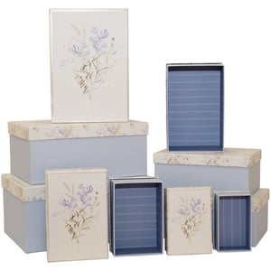 Introduce a touch of timeless elegance to your store with our delightful Forget Me Not 10 Nested Boxes, brought to you by Partisan Products Ltd. This charming set features ten beautifully crafted boxes, designed to nest perfectly within each other for convenient storage and display.

Each box boasts a serene light blue base complemented by an exquisite cream lid adorned with a delicate 'forget-me-not' floral design in soft purples and greens. The thoughtful details continue inside, where a subtle striped blue pattern adds an extra touch of sophistication.

Perfect for gifting, organising, or simply adding a decorative flourish, these versatile boxes are sure to captivate your customers. Offer them a practical yet pretty solution for keepsakes, trinkets, or special presents. Sold as a single pack, they're an ideal addition to any homeware or gift collection.