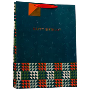 Present gifts beautifully with our Extra Large Trig Gift Bag, available in a wholesale pack of 6 from Partisan Products Ltd. This striking bag features a deep teal background, subtly patterned with geometric outlines. A clear 'HAPPY BIRTHDAY' message shines in gold foil, alongside a distinctive orange and gold corner detail. The lower section boasts a dynamic pattern of orange, dark green, and cream triangles, creating a contemporary look. With its generous size and bright red ribbon handles, this bag is perfect for larger presents, ensuring they make a stylish statement. A great choice for any celebration.