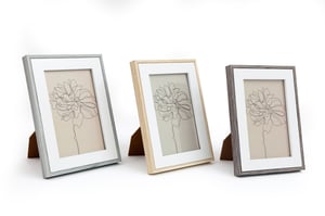 Offer your customers a delightful way to display their favourite moments with our charming 4"x6" White Photo Frames. Each frame boasts a clean white inner mount, perfectly framing photos or artwork. What makes this set truly special is the variety of wooden edge finishes: a contemporary light grey, a warm natural wood, and a sophisticated dark grey. This versatile pack of three ensures there's a style to suit every decor, from modern minimalist to cosy rustic. Ideal for gifting or personal use, these frames are a must-have for any home. Available in a convenient 1x3 pack, making it easy to stock up on this popular item.
