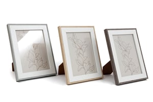 Elevate your retail collection with our stylish 5"x7" White Photo Frames. This versatile pack of three offers a beautiful selection of wooden edge finishes: a chic light grey, a warm natural wood, and a sophisticated dark grey. Each frame features a crisp white mount, perfectly framing 5"x7" photos or artwork and adding a contemporary touch to any space. Designed to stand elegantly on shelves or desks, these frames are ideal for customers seeking to display cherished memories or add a decorative accent. Supplied by Sifcon International PLC, this 1x3 pack is a fantastic addition to any home decor range.