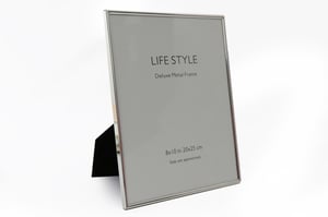 Elevate your cherished memories with our exquisite 8"x10" Silver Plated Edge Photo Frame. This deluxe metal frame, supplied by Sifcon International PLC, brings a touch of timeless elegance to any home or office setting.

Its sleek, silver-plated edge design offers a sophisticated and modern aesthetic, perfect for showcasing your favourite photographs or artwork. The integrated stand ensures versatile display, allowing for both portrait and landscape orientation on any tabletop or shelf.

Measuring 8x10 inches (20x25 cm), this frame is ideally sized for standard prints. Each unit is supplied individually, making it a perfect addition to your retail collection. Offer your customers a beautiful way to highlight their most treasured moments with this stunning and high-quality photo frame.