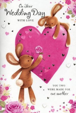 Introduce a touch of adorable charm to your wedding card selection with this delightful 'Wedding Day' card from Simon Elvin. This heartwarming design features two sweet bunny rabbits, one perched playfully on a large pink heart while the other lovingly offers a delicate pink rose. The tender message, 'On Your Wedding Day WITH LOVE' and 'YOU TWO WERE MADE FOR one another', beautifully conveys heartfelt wishes. Adorned with elegant roses and scattered hearts, this card is perfect for celebrating a truly special couple. Stock up with our convenient pack of 6 and offer your customers a truly memorable way to share their congratulations.