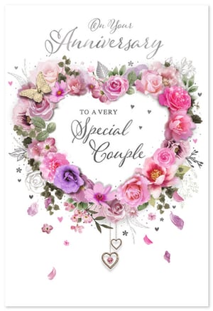 Celebrate enduring love with our exquisite 'Your Wedding Anniversary' card from Simon Elvin. This stunning design features a beautiful heart-shaped wreath, overflowing with delicate pink, purple, and cream flowers, creating a truly romantic feel. A charming butterfly gracefully rests among the blooms, while elegant dangling heart charms add a touch of sparkle. The heartfelt message, "On Your Anniversary, TO A VERY Special Couple," makes this the perfect way to convey warm wishes. Stock up on this gorgeous card, ideal for customers looking to celebrate a special milestone. Available in a convenient pack of 6.