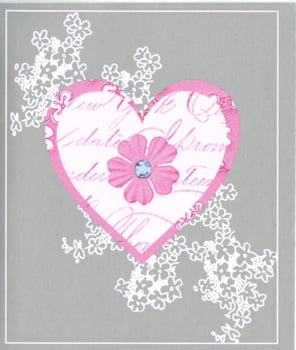 A pink heart with a flower on it is on a gray background.