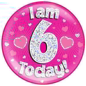 A pink plate with the words "I am 6 today" on it.