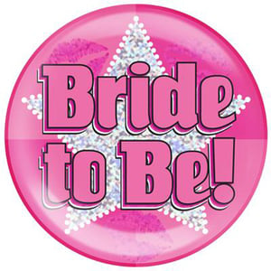 A pink button with the words "bride-to-be" on it.