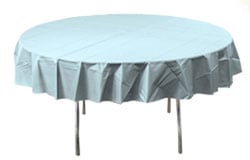 A round table with a light blue tablecloth is on it.