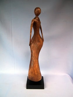 A statue of a woman stands on a black base.