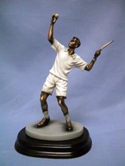 A statue of a man holding a tennis racquet and a tennis ball.