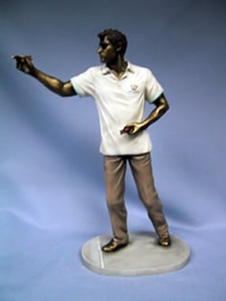 A statue of a man wearing a white shirt and brown pants.
