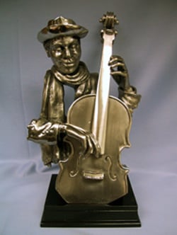 A statue of a man playing a cello with a scarf around his neck.
(Note: The given sentence is grammatically correct and doesn't require any changes.)