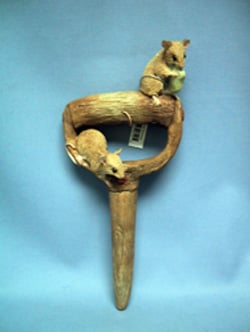 Two mice are sitting atop a wooden stick.