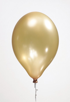 A gold balloon is sitting on a white background.